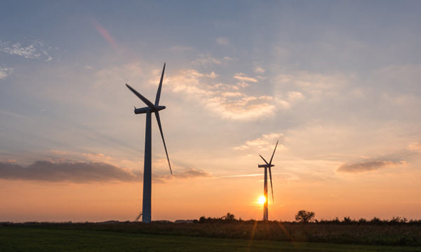 Wind turbines at sunset generating green energy