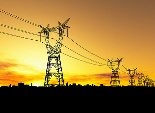 View of power grid lines on a hot sunny day at sunset