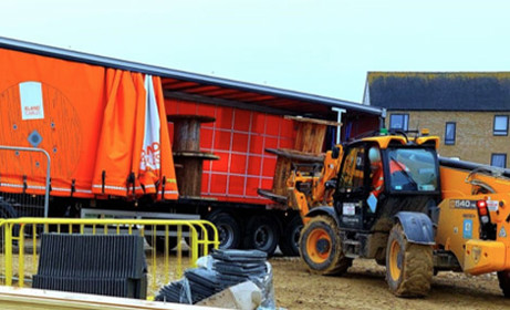 Empty cable drums lifted onto a truck for recycling or reusing